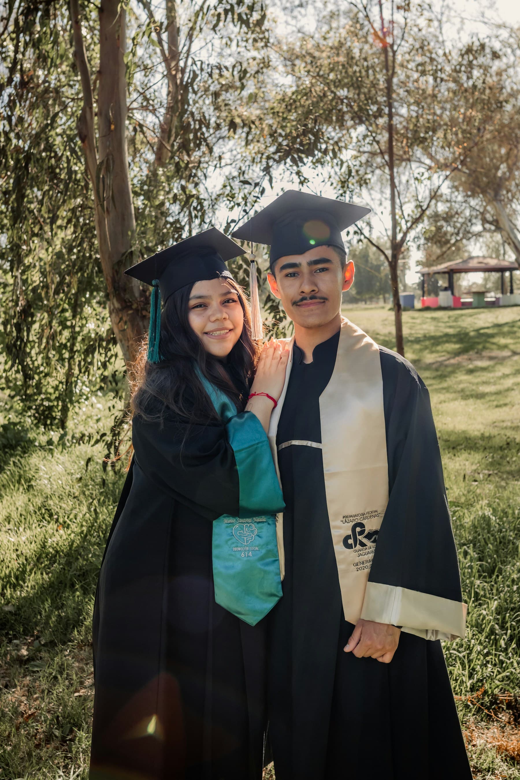 Graduates holding diplomas